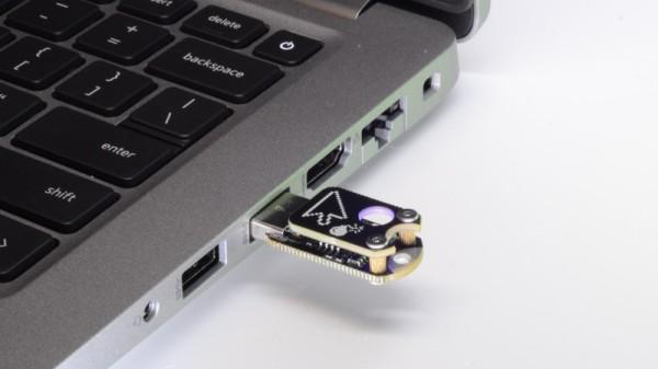 Photo of a laptop with dongle plugged into the USB port