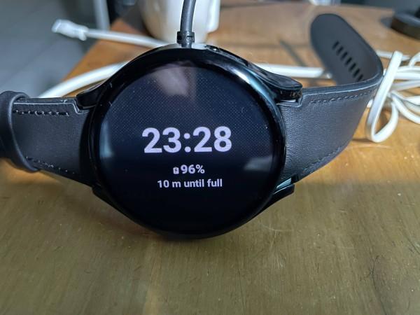 Photo of a Samsung Galaxy Watch 5 showing time and also 96% 10 minutes until full