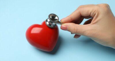 Photo of a red heart with a hand holding a stethoscope to it