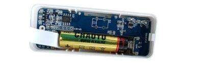 Rectangular printed circuit board, a bit bigger than a AA battery, also has a AA battery slotted onto it