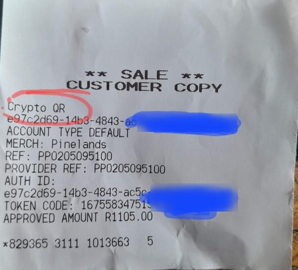 A till slip showing a payment made by CryptoQR with a long number, and other confirmation info for the purchase