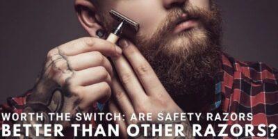 Man with a beard and tattoo on his hand, holding a safety razor against his cheek