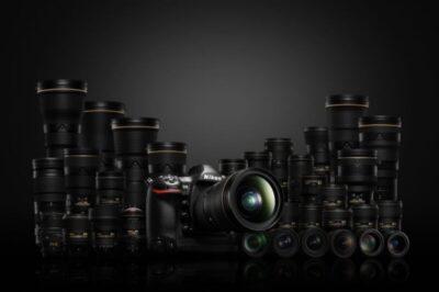 Nikon DSLR camera surrounded by lenses