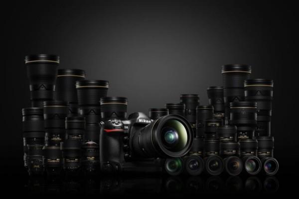 Nikon DSLR camera surrounded by lenses