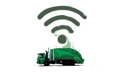 Side view drawing of a green garbage truck, with a Wi-Fi symbol above it