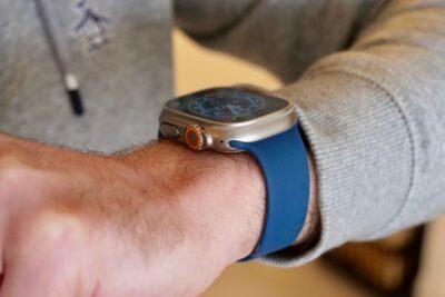 Man's wrist with an Apple Watch that has a blue strap