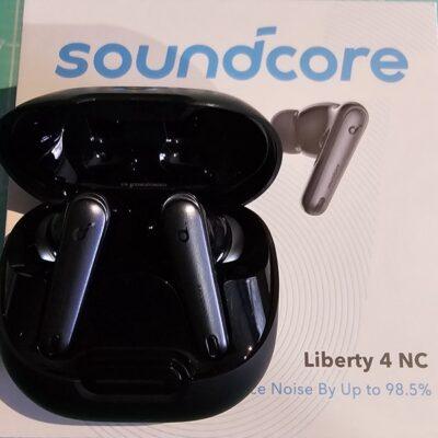 Anker Soundcore Liberty 4 NC packing box, with black earbuds case on top, containing two black earbuds.