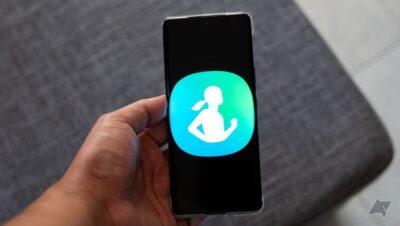 Hand holding a smartphone that has a large icon of Samsung Health filling the whole screen