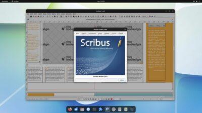 Scribus desktop publication application window showing a newspaper like layout of multiple columns with a larger centre placeholder for a large graphic. A popup window in the centre shows an About window with the Scribus title and version 1.6.0.