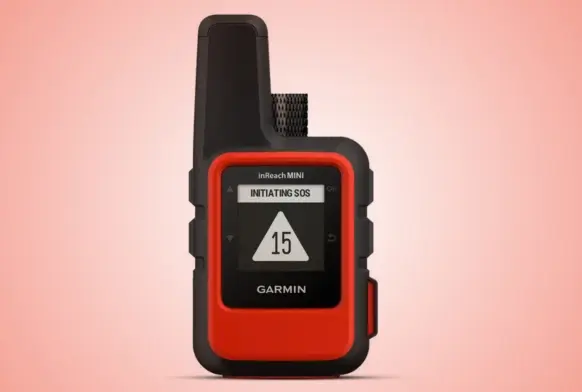 Garmin InReach staellite communicator - looks like a palm size red and black mobile phone. Display shows "Initiating SOS" with the number 15 shown.
