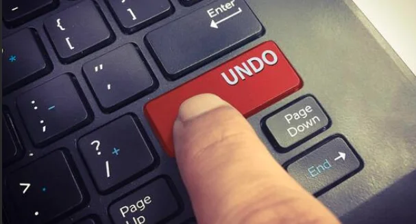 Close view of a keyboard with the right shift key being a bright red key with the word undo on it.