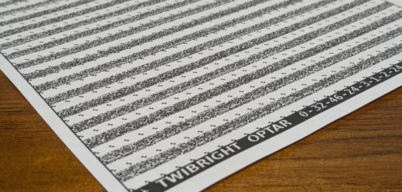 Section of an A4 size paper, showing some horizontal lines made up from a 1 cm patterns of dots. At the bottom is printed in words TWIBRIGHT OPTAR 0-32-46-24-3-1-2-24