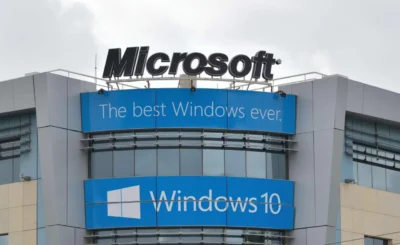 Corner of a grey coloured building with signs on it reading Microsoft The best windows ever, and Windows 10 underneath.