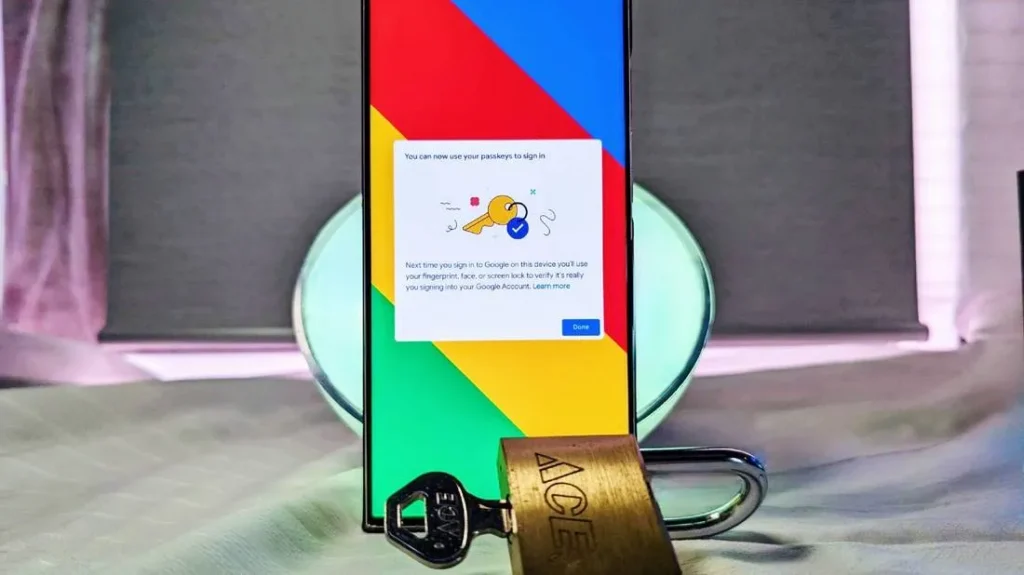 Smartphone show bold blue, red, yellow and green diagonal bars across the screen. In the centre is a pop-up window stating "You can now use your passkeys to sign in". Below it is a graphic showing a yellow key on a keyring, and a blue tick symbol.