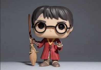 A Funko Pop! figure resembling a young wizard with glasses, wand, and broom, wearing a red robe.