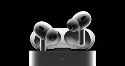 A pair of Apple AirPods Pro resting in their charging case, set against a sleek black background.