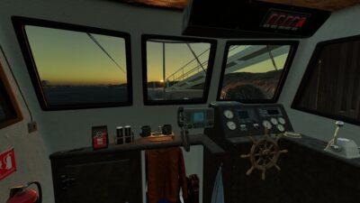 The interior of a boat's control cabin, featuring steering controls, instruments, an ornate wheel, and a sunset view through large windows.
