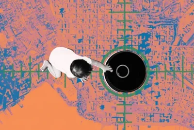 A child reaches towards a large black circular object set against a vibrant, abstract city map background.