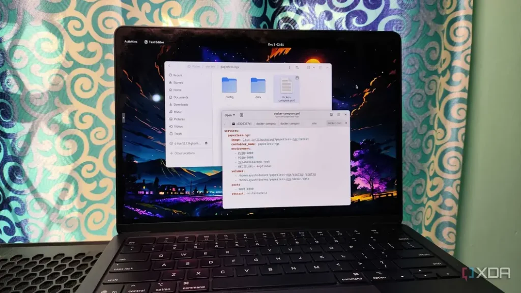 A laptop screen displaying a code editor with a Docker Compose file and file manager, set against a colorful backdrop.