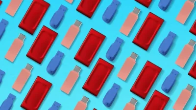 Colorful pattern featuring blue, pink, and red USB drives on a bright blue background.