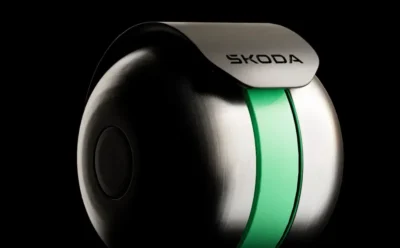 Close-up of a sleek, metallic SKODA device with a green stripe on a black background.