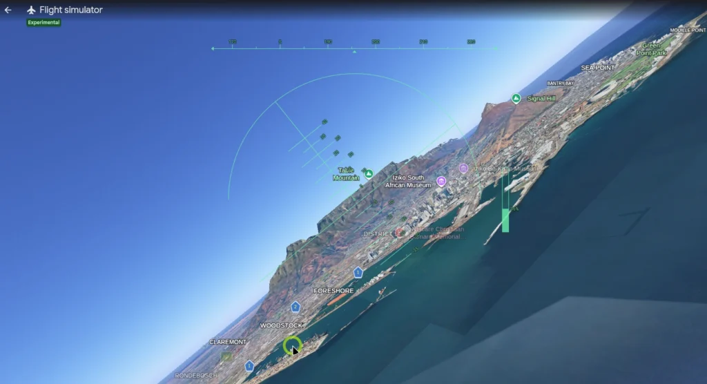 Flight simulator view showing a coastal city with landmarks like Table Mountain, Signal Hill, and Foreshore, tilted over the ocean.