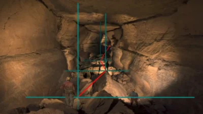 Inside a large rocky cave, miners with helmets explore uneven terrain, overlaid with blue grid lines and a red connecting line.