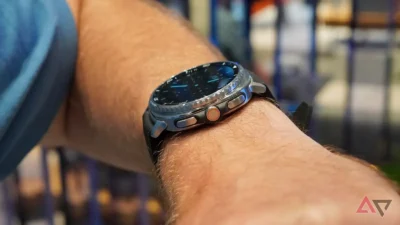 Could flipping Raise wrist to wake and Always On Display (AOD) improve battery life? 8 Close-up of a wristwatch with a black dial and rubber strap worn on a person's arm, with a blurred background.